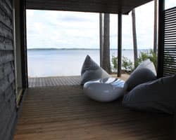 <p data-block-key="gfhmj">Terassin valkea pöytä ja harmaat tuolit sulautuvat Mäntyharjun maisemaan.</p>