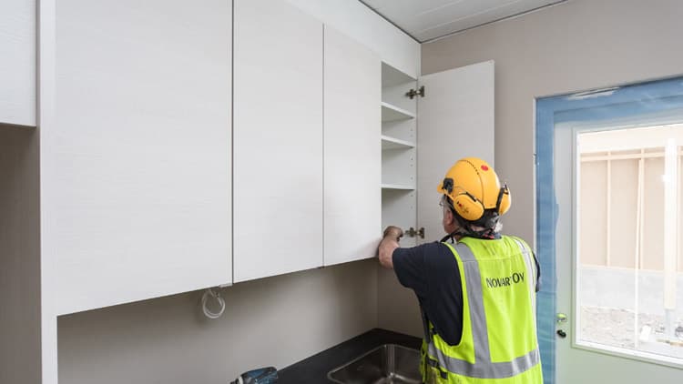 <p data-block-key="ivcrj">Työtehtävät siirtyvät vaihe kerrallaan talosta toiseen. Tässä asennetaan keittiökalusteita paikoilleen.</p>