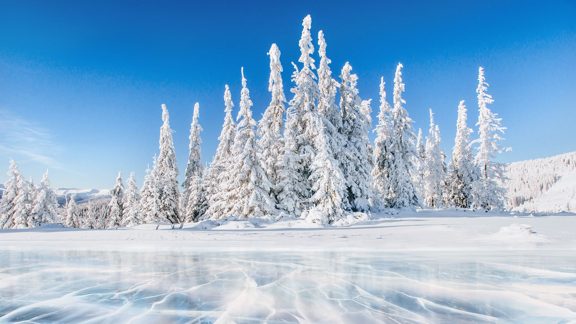 1920 talvinen maisema etualalla jäätynyt järvi jonka vastarannalla lumisia kuusia
