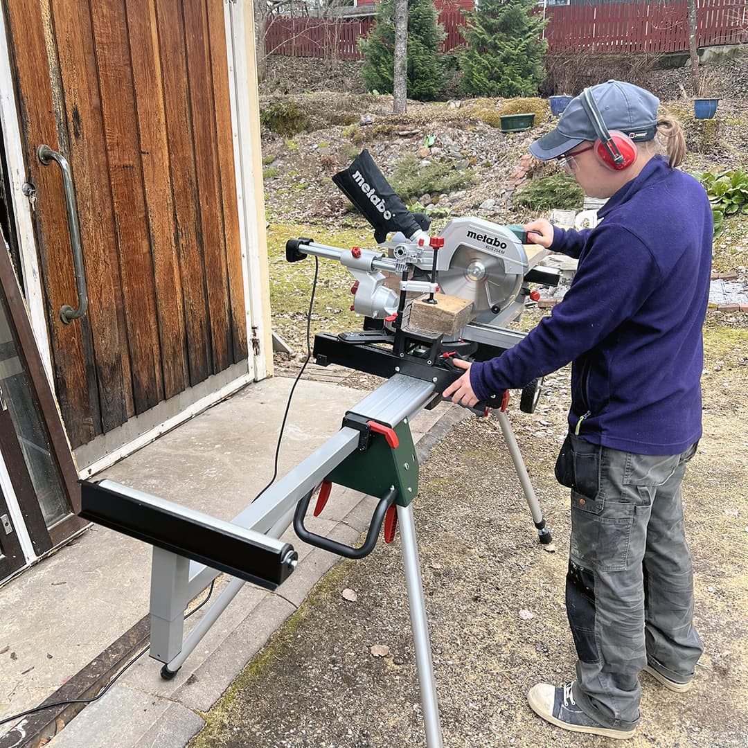 Mies seisoo jalustalla olevan jiirisahan edessä ja sahaa poikki kakkosnelosta parrua