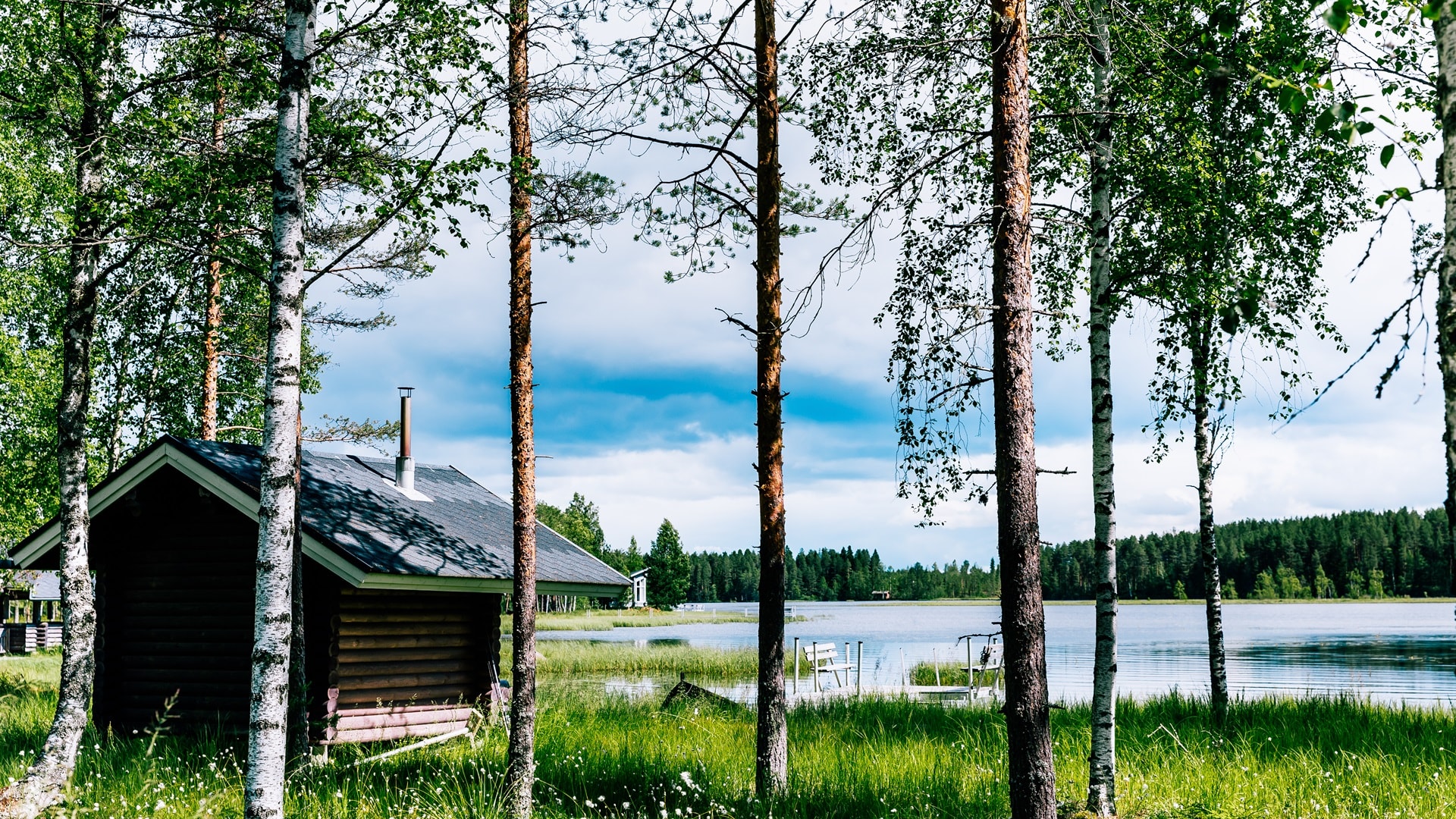 finnish-log-sauna-by-blue-lake-on-summer-day-in-fi-2025-03-18-15-27-50-utc.jpg