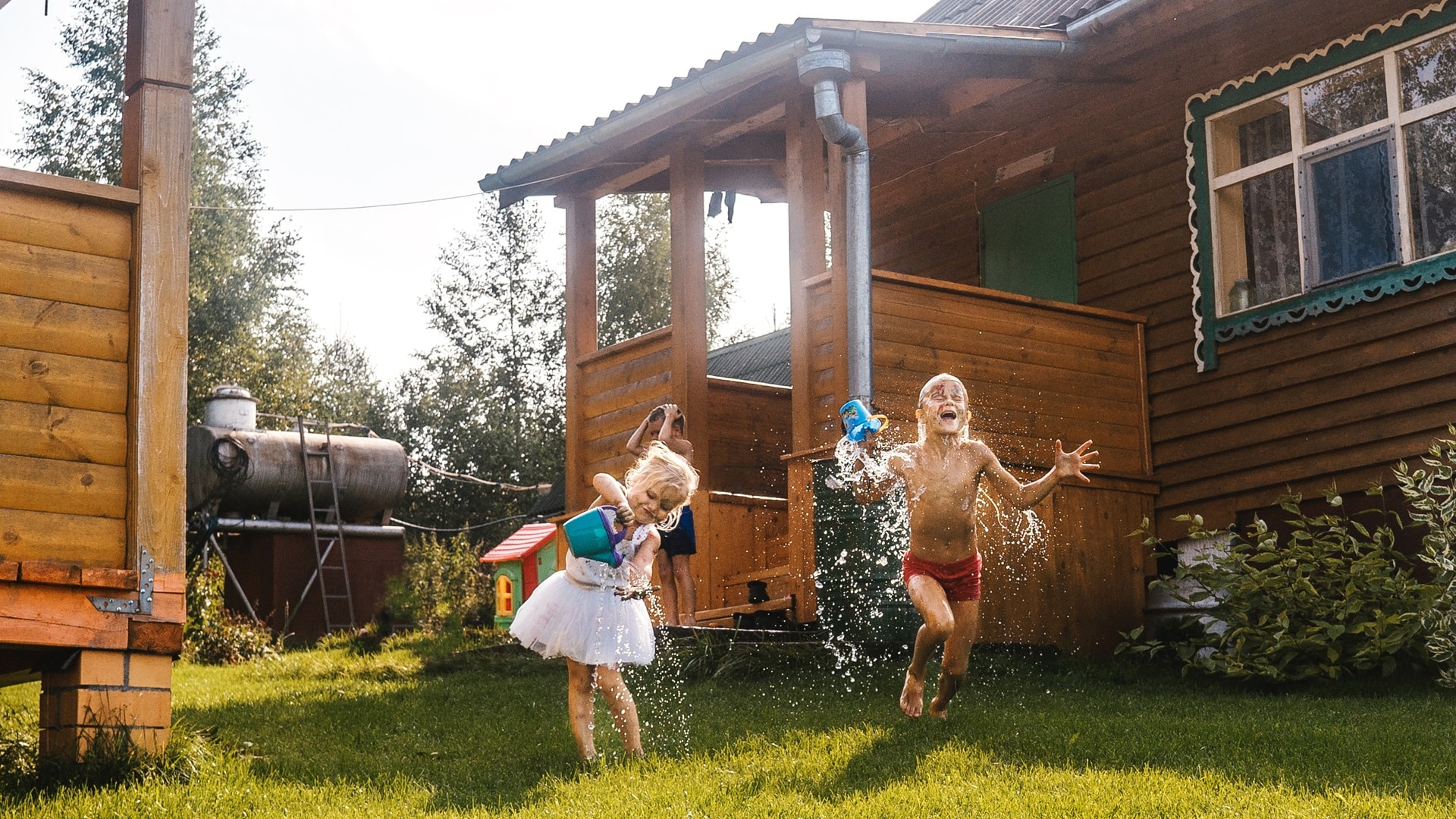 happy-kids-playing-with-water-in-garden-2025-01-08-09-22-37-utc.jpg