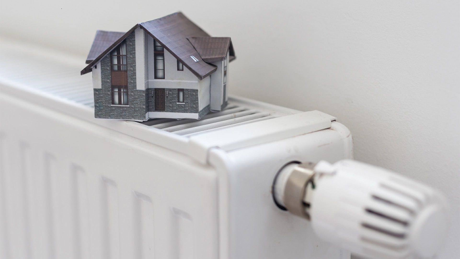model-of-house-on-white-radiator-2025-01-10-02-24-23-utc