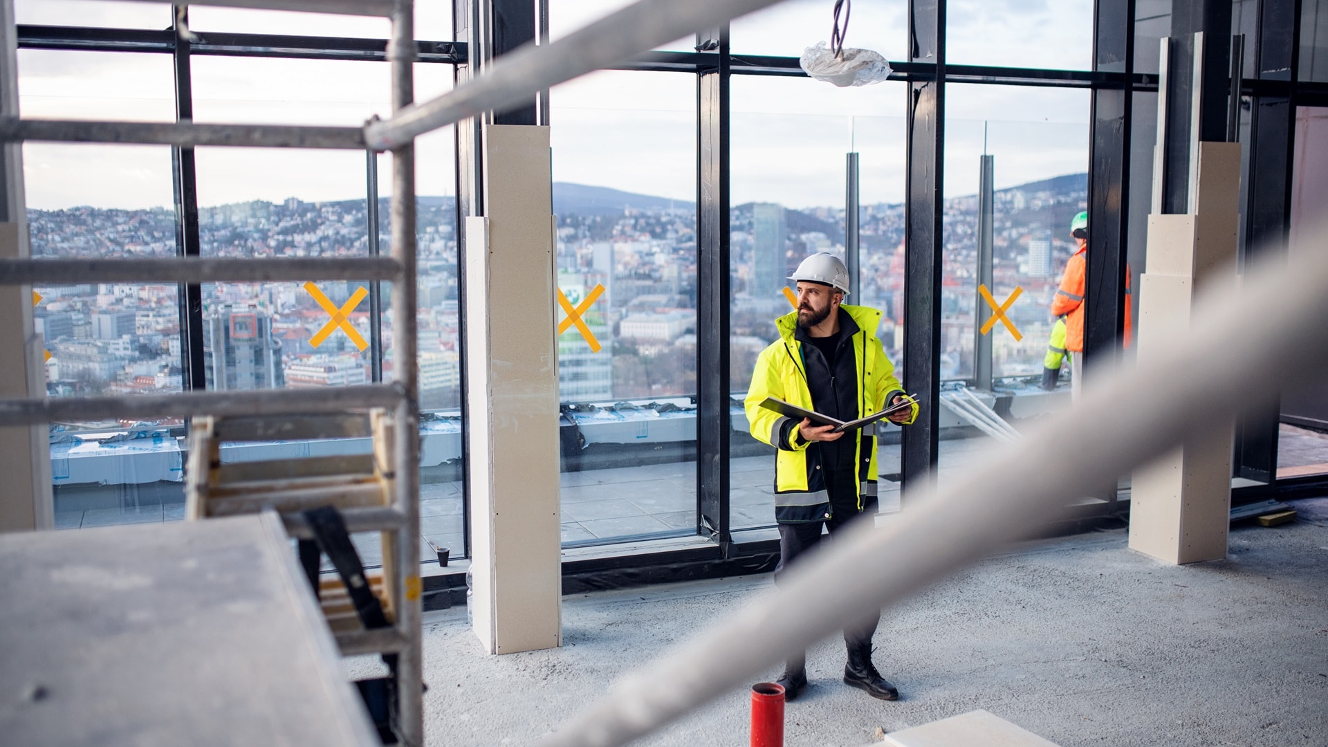 muokman-engineer-standing-on-construction-site-holdin
