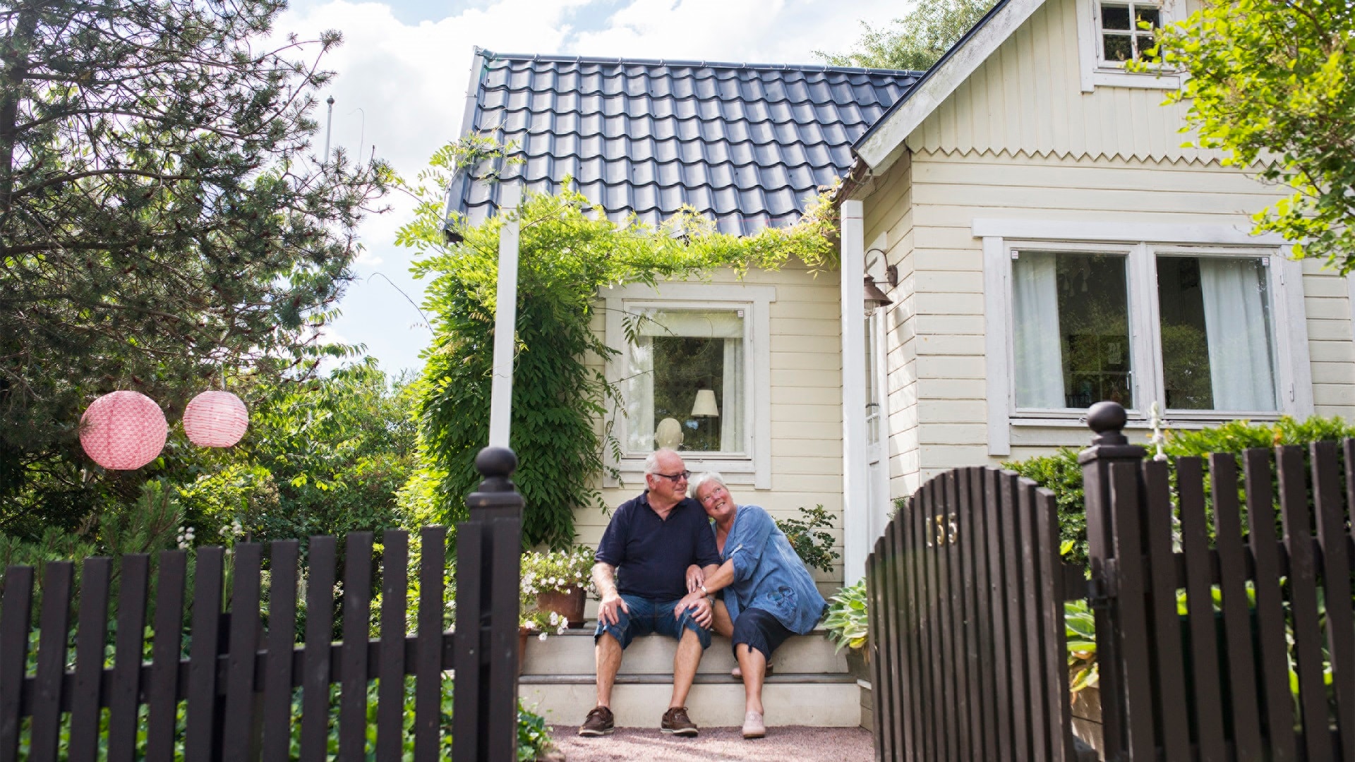 senior-man-and-woman-sitting-on-steps-by-house-2024-10-16-19-45-11-utc.jpg